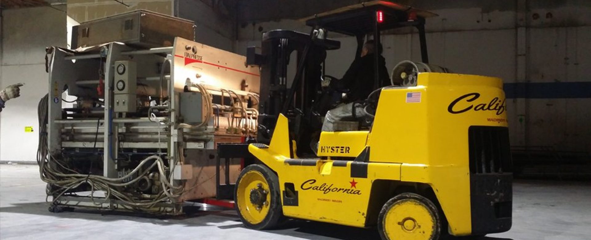 Hyster forklift lifting a large metal container